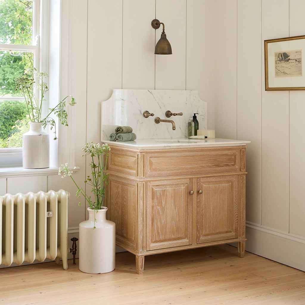 Marble top wooden vanity unit elegant cupboard and symmetrical drawers sit neatly beneath the basin for practicality.